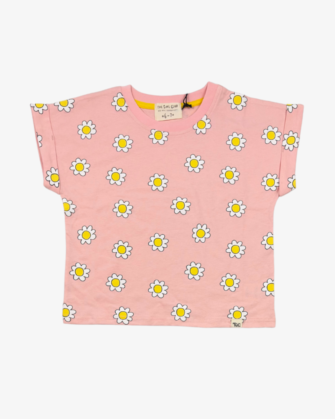 The Girl Club pink kids top with an all-over print of white daisies with yellow centres, cuffed short sleeves and a crew neckline.