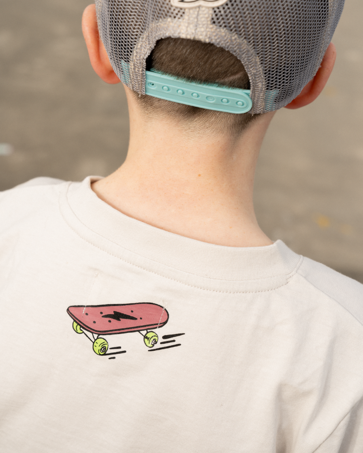 Band of Boys beige tshirt with blue and green stripes and skateboard graphics